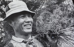 Old photo of asian man working on hawaiian trail
